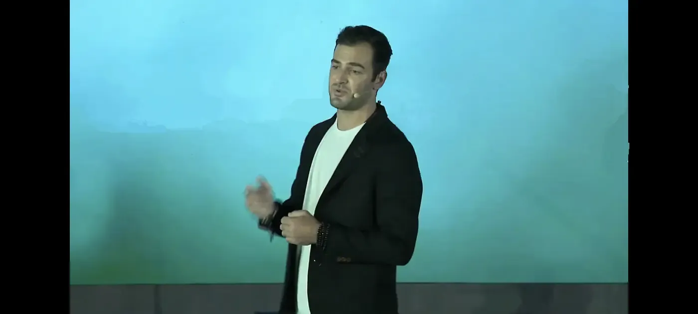Grant Kendzior speaking on stage
